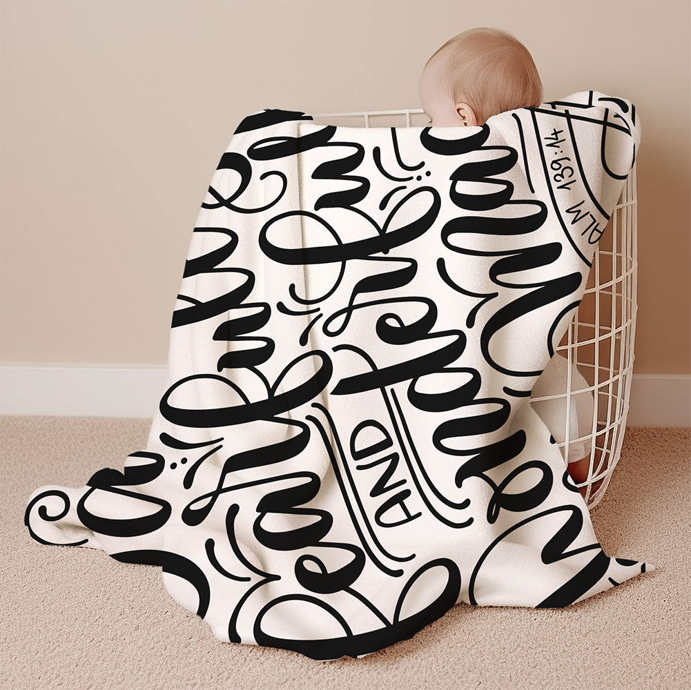 a baby wrapped in a blanket with the word love on it