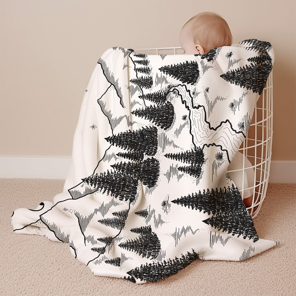 a baby wrapped up in a blanket on the floor