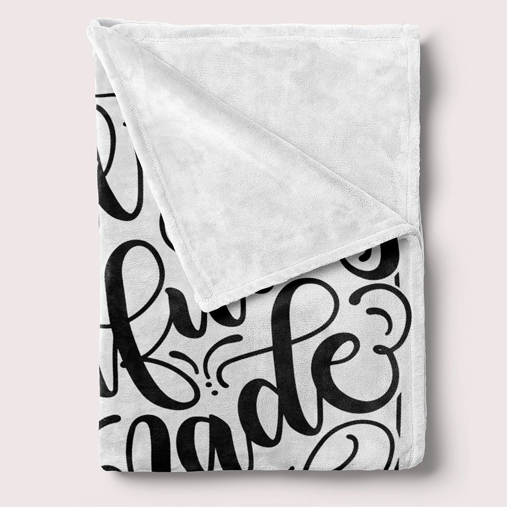 a blanket with a black and white pattern on it