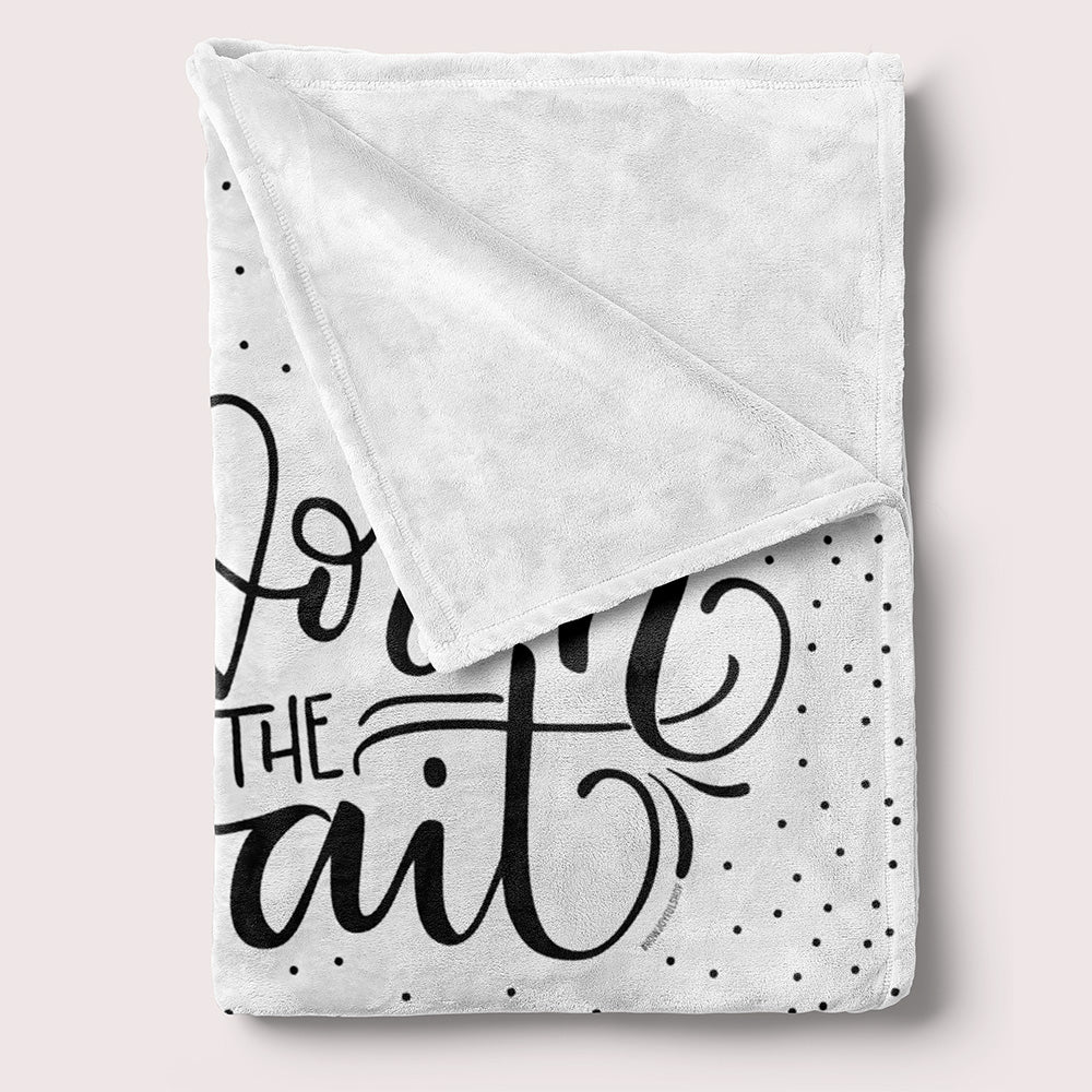 a white blanket with black lettering on it